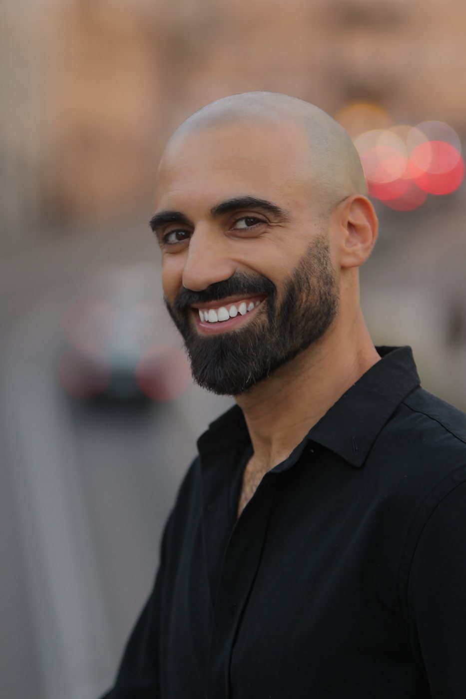 Portrait of Sami Harb smiling, in a black shirt