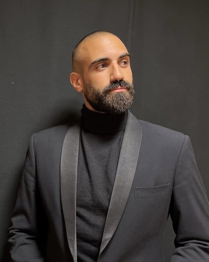 Sami Harb in a black tuxedo jacket and turtleneck